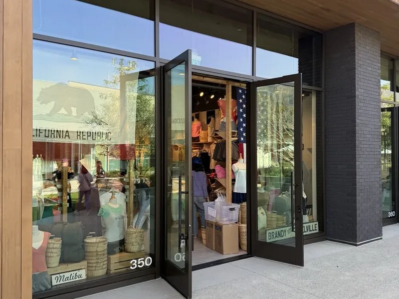 The Brandy Melville storefront at Cross Creek Ranch, glass doors open beneath a cedar soffit